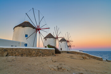 Fototapeta na wymiar Mykonos windmills with sunrise sky,Greece