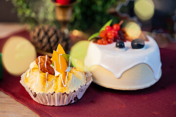 Two decorative fruit cakes with lights and blurred background