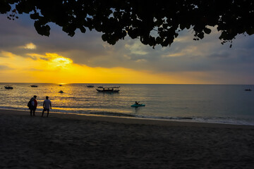 The tourists are enjoying sunset in the Nipah beach, West Nusa Tenggara, Indonesian tourism object