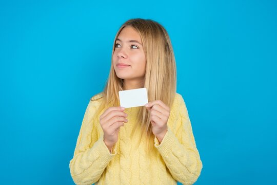 Photo of cheerful MODEL hold debit card look empty space