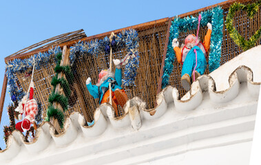 Christmas and New Year decorations on Spanish houses. Colorful dwarves.
White architecture in Spain.