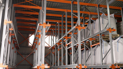 Chemical products warehouse. Warehouse with metal shelves and bags of salt.