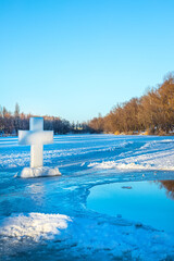 Holidays of Orthodox baptism. Ice cross hole and a cross of ice in Ukraine