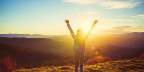 Fototapeta premium A person stands triumphant on a hill, arms raised to the radiant morning sun, bursting with positive energy.