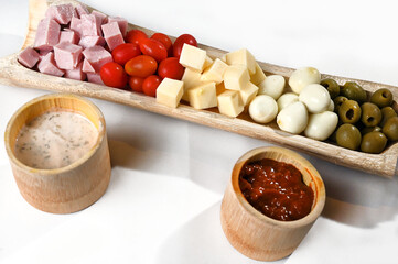portion of cold snacks cheese ham olive oil