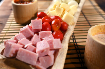 portion of cold snacks cheese ham olive oil