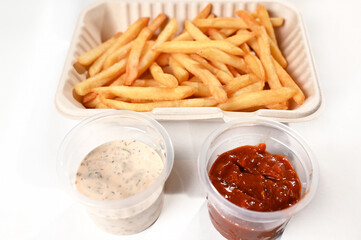 food tray french fries sausage white sausage and red sauce german food