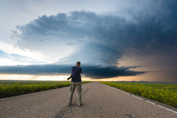 Storm Chaser Photographer Capuring The Moment A Huge Storm Crosses The Road