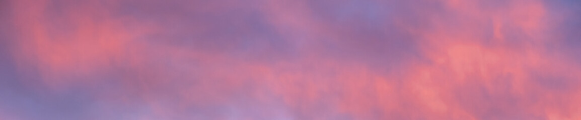 Colorful sunset sky in purples, pinks, oranges, and blues, beautiful cloudscape background