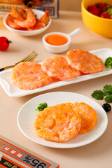 Shrimp steaks, snack made with shrimps and vegetables, children's food fried, golden and pink meat texture, closeup on tabletop indoors
