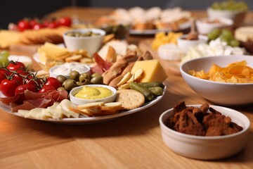 Assorted appetizers served on wooden table, closeup