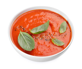 Delicious tomato soup with basil and spices isolated on white