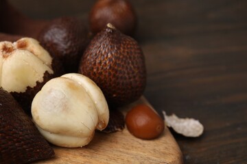 Fresh salak fruits on wooden table, closeup. Space for text