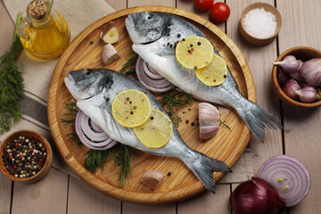 Fototapeta premium Flat lay composition with raw dorado fish on wooden table