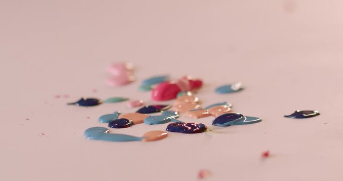 Close-up of Children's hands smearing paint on a sheet of paper is expression of creativity and childhood development. Smearing paint engages children in sensory exploration. Kids hands closeup.
