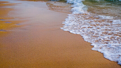 waves crashing on the white sand beach