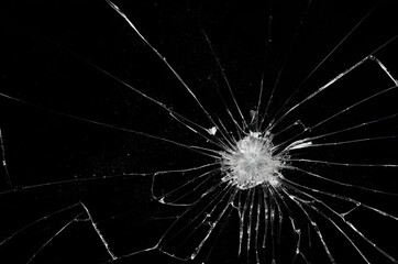 Obraz premium Broken glass on a black background, cracks, shards.