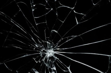Broken glass on a black background, cracks, shards.