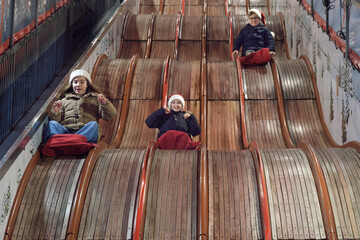 Classic slides in an amusement park. Children have fun sliding down a slide