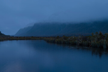 Photograph of a mountain range behind Mirror Lakes in Fiordland National Park on the South Island of New Zealand