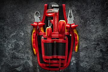 Red Working Tools In Tool Belt On Black Background.