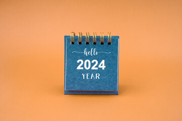 Hello 2024 calendar on brown background.