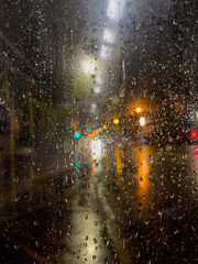 Rain bokeh road lights. Abstract shot of evening city traffic bokeh. Multicolored lights of the...