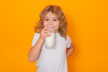 Milk. Child with glass of milk on studio yellow background. Kid with milk moustache. Fun portrait...
