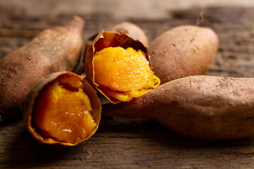 Perfect baked Japanese sweet potato, Annou Imo Beni on wooden table background.