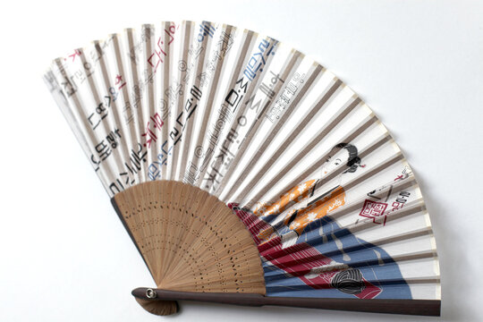 A buchae or traditional Korean fan which is often highly decorated.