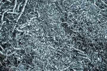 Close-up of aluminum shavings after processing parts on a lathe. Material recycling concepts.
