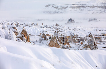 Pigeon Valley and Cave town in Göreme in winter, Fairy chimneys, Cappadocia, Turkey.
