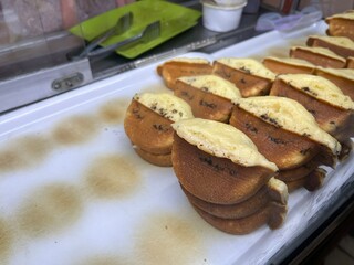 Indonesian traditional cake named Kue Pukis made from flour, eggs, yeast and coconut milk in a glass display for sale