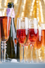 glasses of rose champagne on sparkling golden cloth