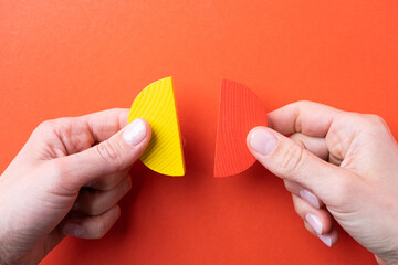 hands working with colorful wooden pie chart pieces