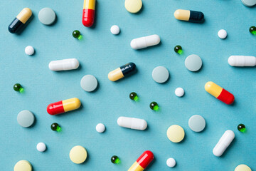 Different pills on color background, flat lay