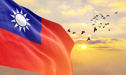 Waving flag of Taiwan against the background of a sunset or sunrise. Taiwan flag for Independence Day. The symbol of the state on wavy fabric.