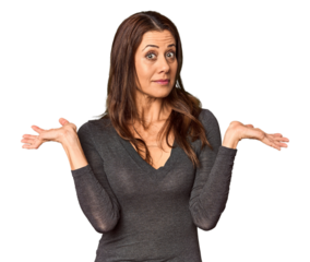 Elegant middle-aged Caucasian woman in studio setting doubting and shrugging shoulders in questioning gesture.