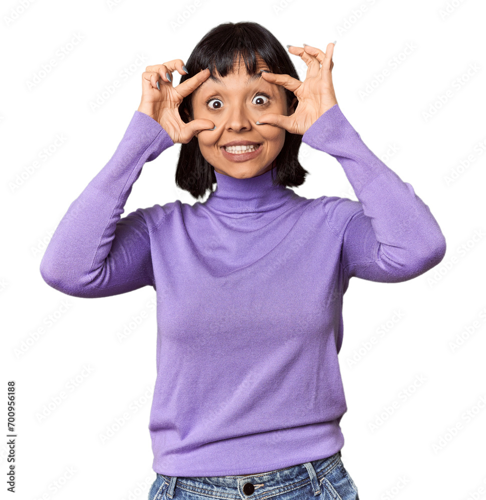 Wall mural Young Hispanic woman with short black hair in studio keeping eyes opened to find a success opportunity.