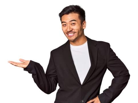 Young Chinese man in business suit in studio looking sideways with doubtful and skeptical expression.