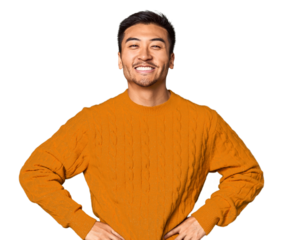 Young Chinese man in studio background confident keeping hands on hips.