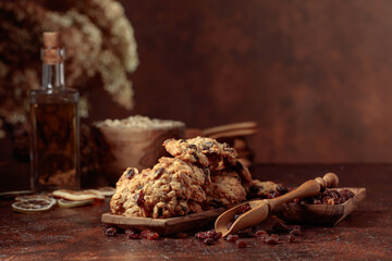 Oatmeal raisin cookies on a brown table.