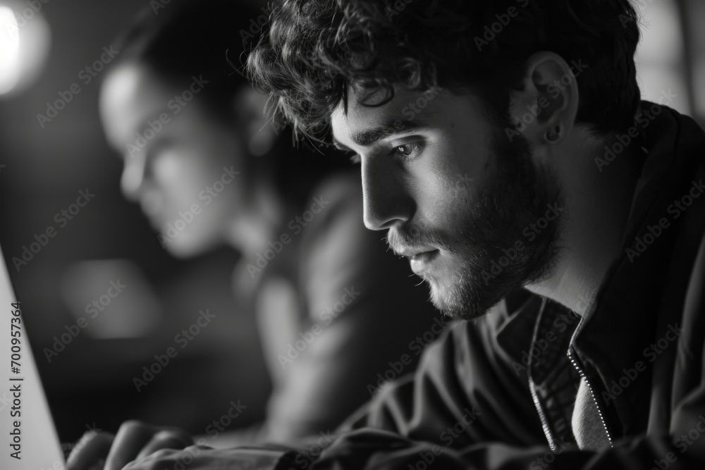 Poster A man sitting in front of a laptop computer. Perfect for illustrating modern technology and remote work