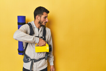 Young Hispanic man with lantern and backpack - obrazy, fototapety, plakaty