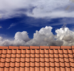 Roof tiles and blue sky with clouds