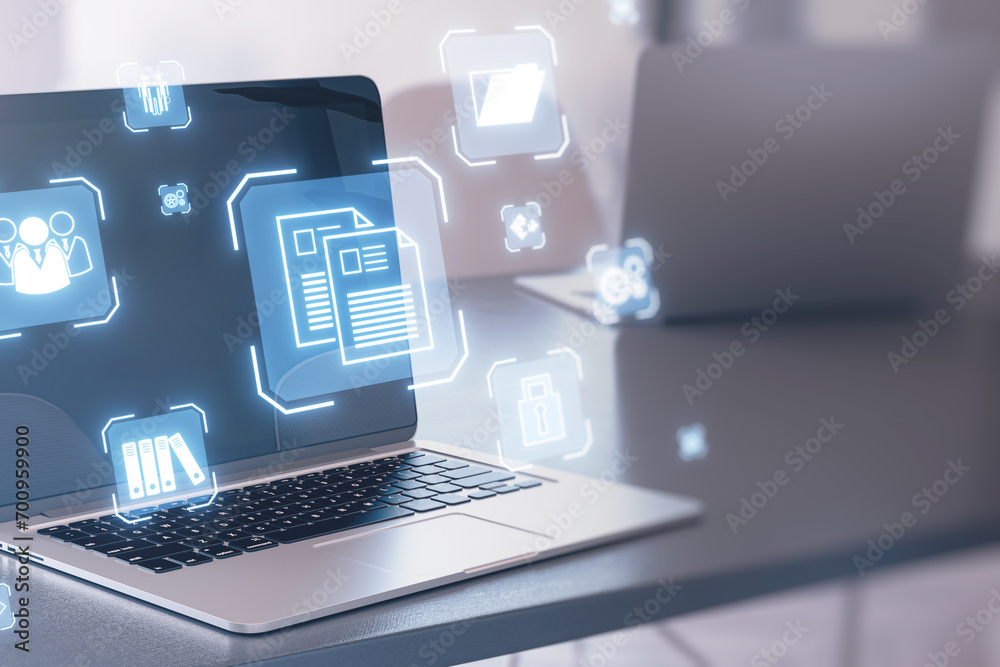 Poster close up of laptop on desk with glowing blue icons on blurry background. online management and remot