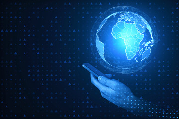 Close up of pixel hands holding smartphone with digital polygonal globes on blue background. Global...