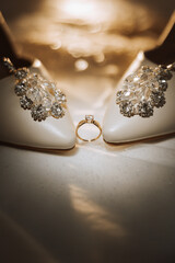 Details of the bride. Beauty is in the details. High-heeled bridal shoes. Gold wedding ring with a diamond. Perfumes. Earrings Wedding in details.