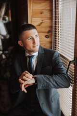 A stylish portrait of the groom preparing for the wedding ceremony in the morning. Groom's morning....