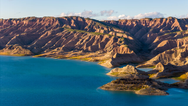 Aerial drone photo of the lake surrounded by mountains named Negratin in Spain